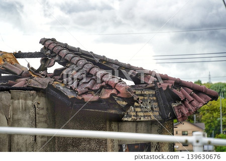 A dilapidated abandoned house, the aftermath of a fire. A dilapidated abandoned house, the aftermath of a fire. 139630676