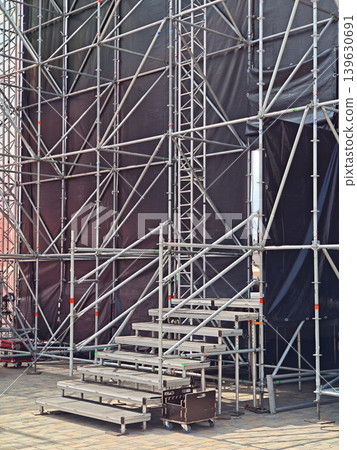 Outdoor concert stage scaffolding of silver metal truss and platforms Outdoor concert stage scaffolding of silver metal truss and platforms 139630691
