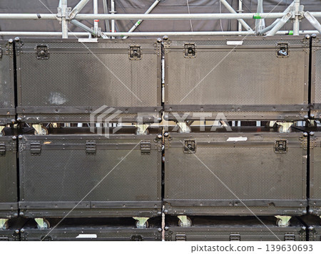 Stack of black flight cases on wheels used for concert and event production Stack of black flight cases on wheels used for concert and event production 139630693