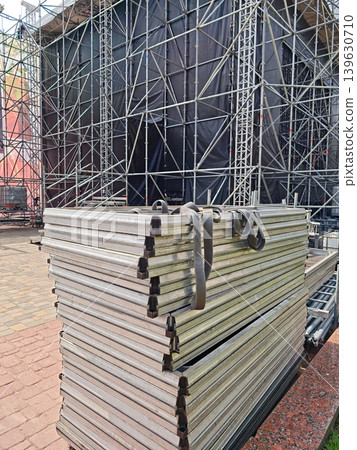 Stacked aluminum stage platforms with lifting straps, ready for assembly Stacked aluminum stage platforms with lifting straps, ready for assembly 139630710