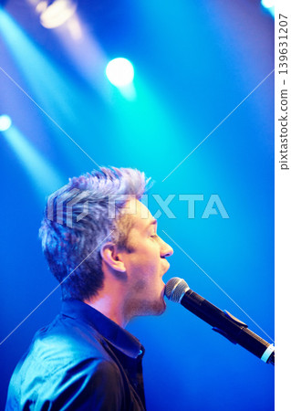 Man, singing and performing at night, concert and stage for music festival, party and entertaining crowd. Microphone, musician and rave on weekend, event and rockstar in club for celebration Man, singing and performing at night, concert and stage for music festival, party and entertaining crowd. Microphone, musician and rave on weekend, event and rockstar in club for celebration 139631207