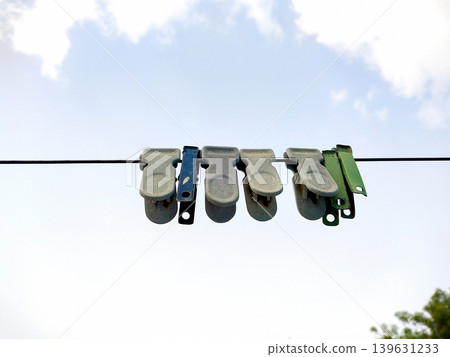 Colorful Clothespins Hanging on Laundry Line Outdoors Colorful Clothespins Hanging on Laundry Line Outdoors 139631233