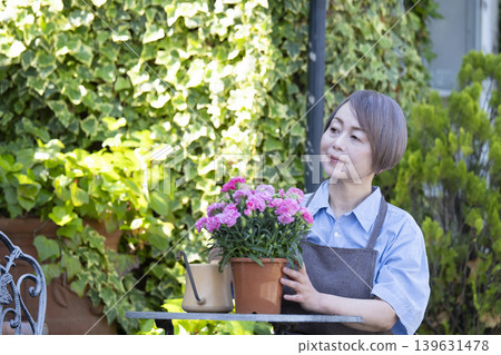 Senior women enjoying gardening in their yards Senior women enjoying gardening in their yards 139631478