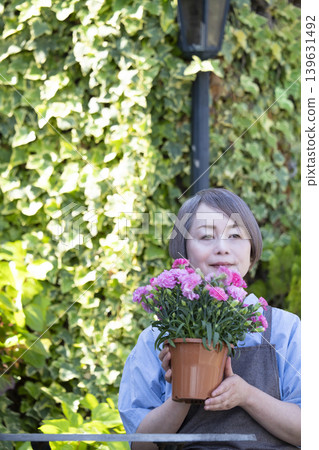 Senior women enjoying gardening in their yards 139631492