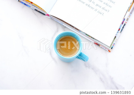 An image of enjoying reading while drinking coffee with an open book (Western book) and a coffee cup with coffee in it. An image of enjoying reading while drinking coffee with an open book (Western book) and a coffee cup with coffee in it. 139631893