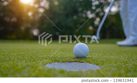 Golfers are putting golf in the evening golf course golf backglound. Golfers are putting golf in the evening golf course golf backglound. 139631941