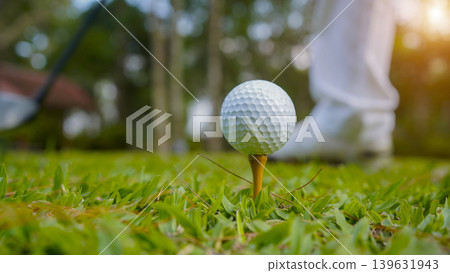 Golf ball on tee in a beautiful golf course with morning sunshine. 139631943