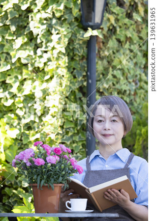 A senior woman reading in the garden A senior woman reading in the garden 139631965