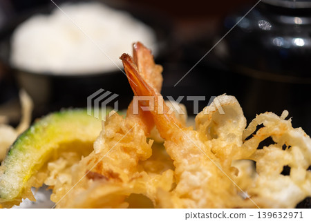 Crispy shrimp tempura served with fried vegetables in Japanese style cuisine featuring golden batter texture and delicious seafood presentation Crispy shrimp tempura served with fried vegetables in Japanese style cuisine featuring golden batter texture and delicious seafood presentation 139632971