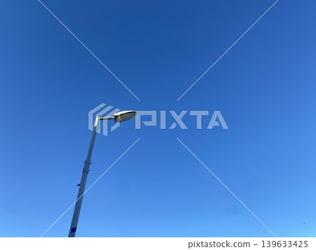 A simple urban landscape of streetlights against the blue Tokyo sky. A simple urban landscape of streetlights against the blue Tokyo sky. 139633425