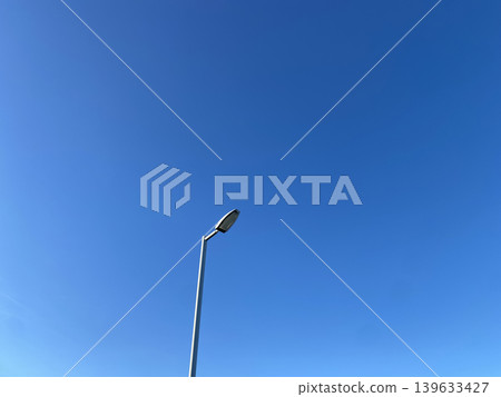A simple urban landscape of streetlights against the blue Tokyo sky. A simple urban landscape of streetlights against the blue Tokyo sky. 139633427