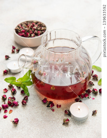 Rose tea brewing in glass teapot with dried buds Rose tea brewing in glass teapot with dried buds 139633592