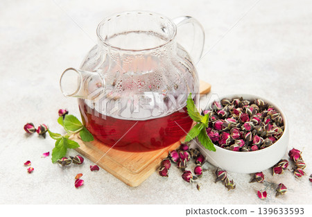 Glass teapot brewing herbal rosebud tea with mint Glass teapot brewing herbal rosebud tea with mint 139633593