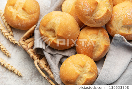 Freshly baked bread rolls in a woven basket Freshly baked bread rolls in a woven basket 139633598