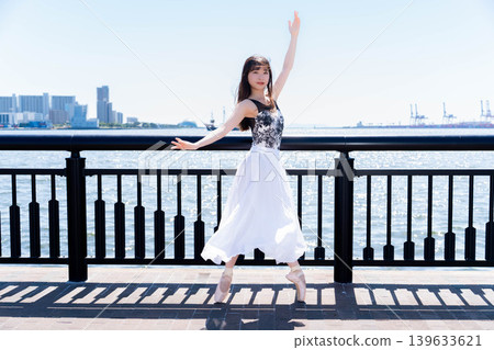 Japanese ballerina dancing against the backdrop of the sea 139633621