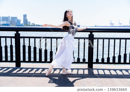 Japanese ballerina dancing against the backdrop of the sea Japanese ballerina dancing against the backdrop of the sea 139633669