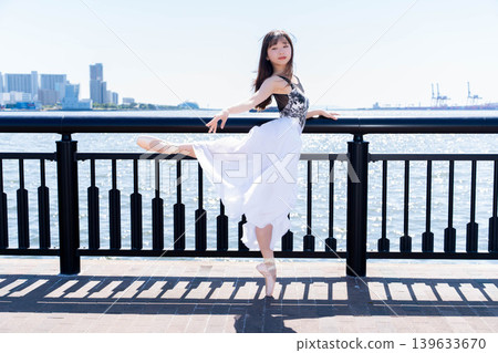 Japanese ballerina dancing against the backdrop of the sea Japanese ballerina dancing against the backdrop of the sea 139633670