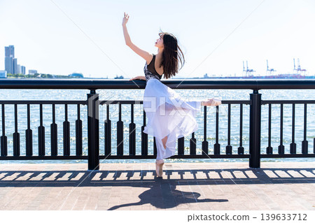 Japanese ballerina dancing against the backdrop of the sea Japanese ballerina dancing against the backdrop of the sea 139633712