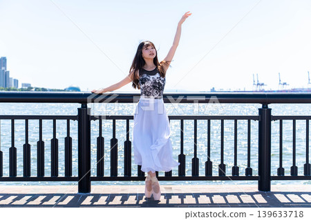 Japanese ballerina dancing against the backdrop of the sea Japanese ballerina dancing against the backdrop of the sea 139633718