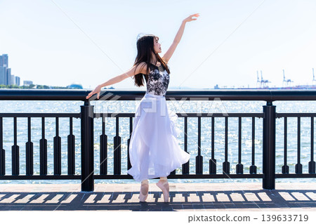 Japanese ballerina dancing against the backdrop of the sea Japanese ballerina dancing against the backdrop of the sea 139633719