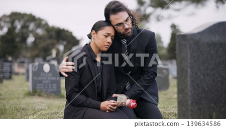 Sad couple, rose and graveyard in loss, grief or mourning at funeral, tombstone or cemetery. Man and woman hug with flower in depression, death or goodbye at memorial or burial service for loved one Sad couple, rose and graveyard in loss, grief or mourning at funeral, tombstone or cemetery. Man and woman hug with flower in depression, death or goodbye at memorial or burial service for loved one 139634586