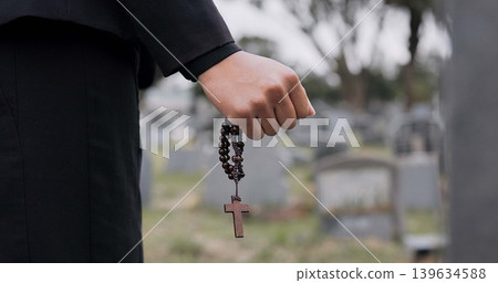 Rosary, death or hand cemetery for funeral. spiritual service or grave visit to repsect the Christian religion. Mourning, goodbye or closeup of person outside in graveyard for grief, loss or farewell 139634588