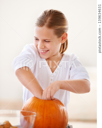 Girl, child and happy with pumpkin for halloween, celebration or decoration in kitchen of apartment or home. Kid, face and smile with vegetable for preparation, holiday or creative event in house Girl, child and happy with pumpkin for halloween, celebration or decoration in kitchen of apartment or home. Kid, face and smile with vegetable for preparation, holiday or creative event in house 139634631