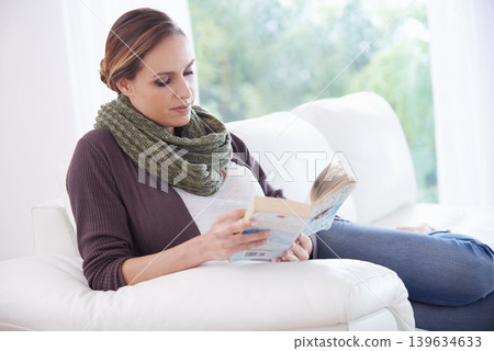 Woman, book and reading on sofa to relax for story, novel and learning knowledge in living room at home. Lady, fiction books and break for studying literature, hobby or comfortable on couch in lounge Woman, book and reading on sofa to relax for story, novel and learning knowledge in living room at home. Lady, fiction books and break for studying literature, hobby or comfortable on couch in lounge 139634633