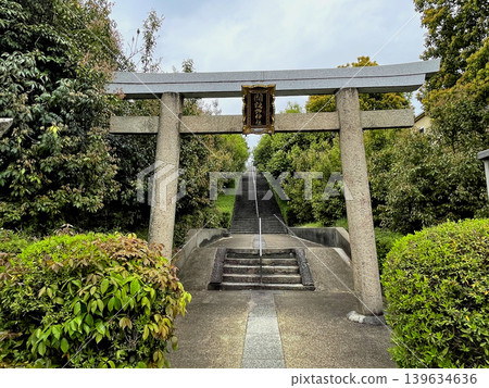 Toukeino Shrine: Stone torii gate with a plaque in front of the approach to the shrine, which crosses the stone steps and the Meishin Expressway. Toukeino Shrine: Stone torii gate with a plaque in front of the approach to the shrine, which crosses the stone steps and the Meishin Expressway. 139634636