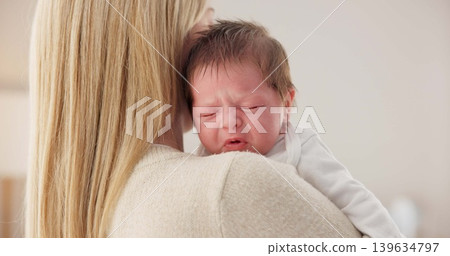 Comfort, mother and a crying newborn for love, care and sad in the morning. House, family and a young mom or woman with affection, support and holding a baby, child or kid for sleep, rest or tired Comfort, mother and a crying newborn for love, care and sad in the morning. House, family and a young mom or woman with affection, support and holding a baby, child or kid for sleep, rest or tired 139634797
