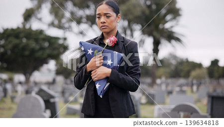 Funeral, rose and american flag with a woman at a cemetery in mourning at a memorial service. Sad, usa and an army wife as the widow of a patriot in a graveyard, feeling pain of death, loss or grief Funeral, rose and american flag with a woman at a cemetery in mourning at a memorial service. Sad, usa and an army wife as the widow of a patriot in a graveyard, feeling pain of death, loss or grief 139634818