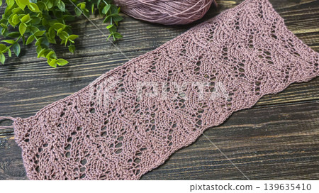 Knitting patterns with a raised pattern and yarn in different colors. Copy space 139635410