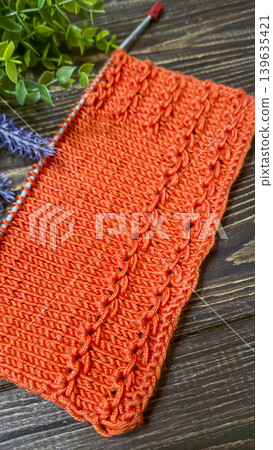 Knitting patterns with a raised pattern and yarn in different colors. Copy space Knitting patterns with a raised pattern and yarn in different colors. Copy space 139635421