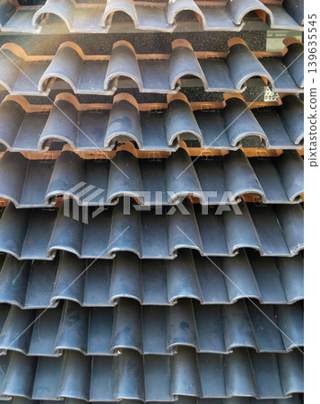 Rows of Stacked Black Double Roman Concrete Roof Tiles 139635545