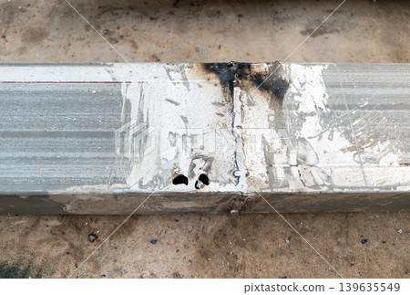 Damaged Metal Weld Joint with Burn Marks and Corrosion 139635549