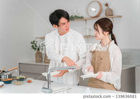 A couple arguing or fighting in the kitchen. A couple arguing or fighting in the kitchen. 139636081