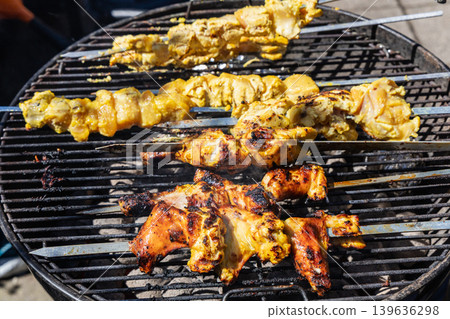 Grilled chicken wings cooking on barbecue grill with golden crispy crust. Grilled chicken wings cooking on barbecue grill with golden crispy crust. 139636298