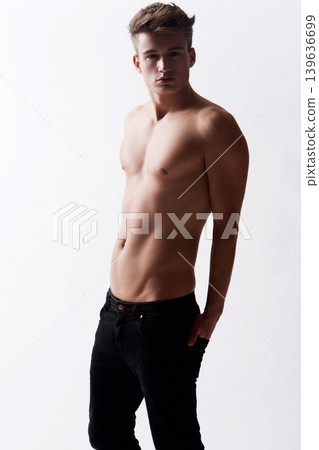 Portrait, natural and masculine with body of man in studio on white background for health or wellness. Aesthetic, beauty and skin with young shirtless model in jeans for hygiene and satisfaction Portrait, natural and masculine with body of man in studio on white background for health or wellness. Aesthetic, beauty and skin with young shirtless model in jeans for hygiene and satisfaction 139636699