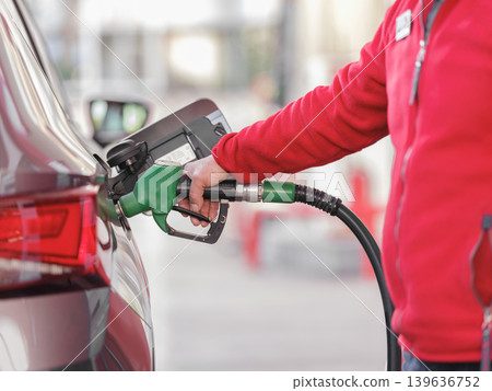 Pumping gas at gas pump. Closeup of man pumping gasoline fuel in car at gas station. Pumping gas at gas pump. Closeup of man pumping gasoline fuel in car at gas station. 139636752