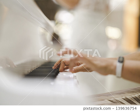 a woman playing the piano a woman playing the piano 139636754