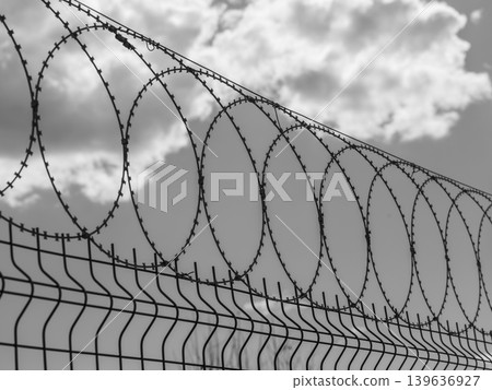 barbed wire on prison wall barbed wire on prison wall 139636927