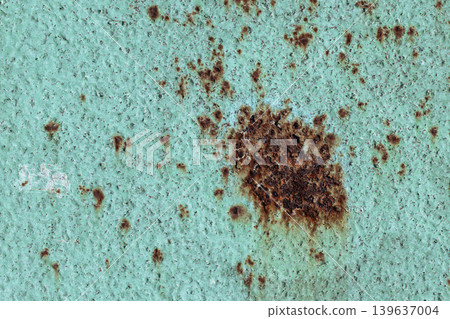 Large Rust Spot on Turquoise Metal Surface: Corroded Paint Texture with Brown Oxidation. Vintage Grunge Background Large Rust Spot on Turquoise Metal Surface: Corroded Paint Texture with Brown Oxidation. Vintage Grunge Background 139637004