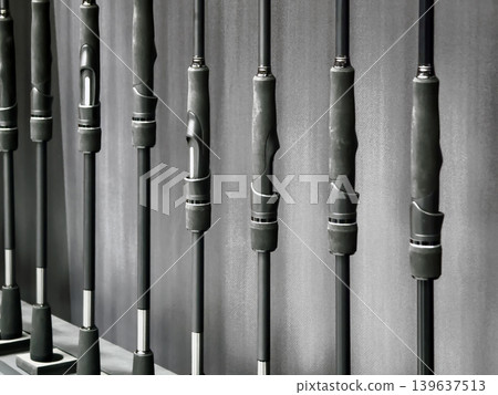 Fishing rods are displayed neatly on a wall in a store showing various models and sizes for fishing enthusiasts 139637513