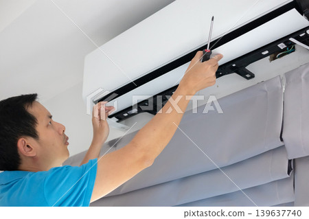 Electrician man repair and maintenance air conditioner 139637740