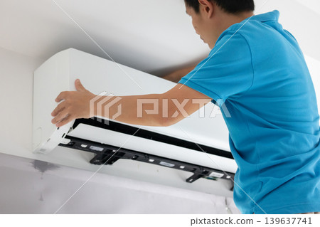 Electrician man repair and maintenance air conditioner 139637741