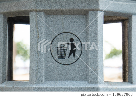 Public waste disposal symbol on concrete surface representing cleanliness, recycling awareness, environmental responsibility, and proper trash management in urban public spaces. Public waste disposal symbol on concrete surface representing cleanliness, recycling awareness, environmental responsibility, and proper trash management in urban public spaces. 139637903