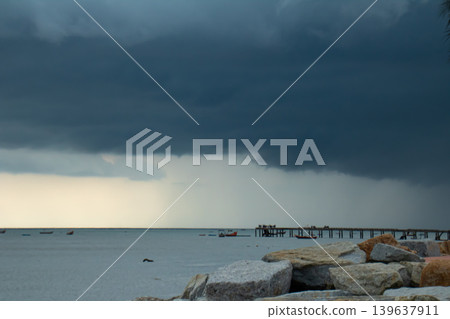 Storm cloud seascape rocky shore calm water pier horizon dark sky rain shower cloudy sky coastal landscape Storm cloud seascape rocky shore calm water pier horizon dark sky rain shower cloudy sky coastal landscape 139637911