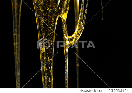 Creative honey swirl on black background. Creative honey swirl on black background. 139638154