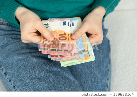 Hands holding and counting Euros. European Union currency. 139638164