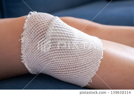wound dressing bandage on child knee after fall on the ground wound dressing bandage on child knee after fall on the ground 139638314